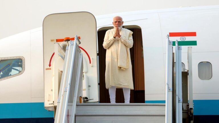 Prime Minister Narendra Modi is welcomed by Bhutanese Prime Minister Tshering Tobgay upon his arrival at Paro International Airport, marking the start of his two-day visit to Bhutan to attend the 70th birthday celebrations of the Fourth King, Jigme Singye Wangchuck. (PC: PTI)