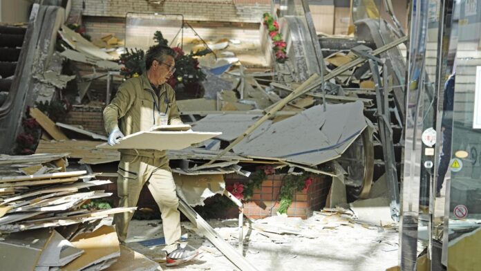 A man clears debris at a commercial facility in Hachinohe, Aomori Prefecture, after a powerful 7.5-magnitude earthquake struck northern Japan, injuring dozens and triggering small tsunami waves. (PC: AP)